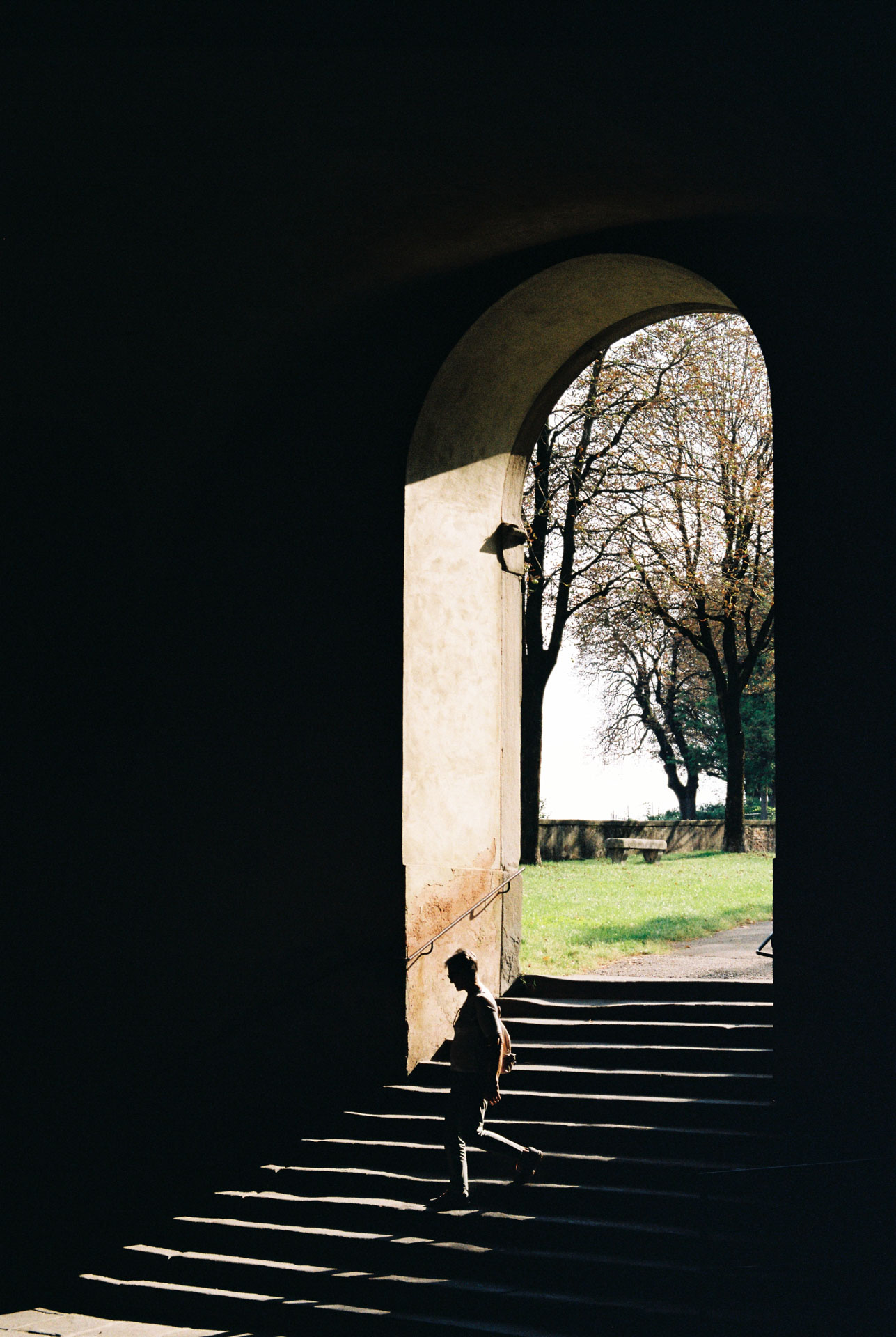 A man walking down Sant'Agostino Gate in Citta alta, Bergamo, Italy on Kodak Gold 200 film stock.