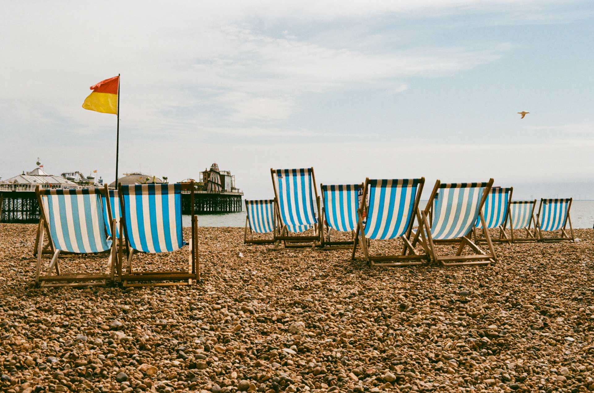 Brighton beach chairs on the beachfront looking over at the Brighton palace pier on a summer's day on Kodak Gold 200 film stock.