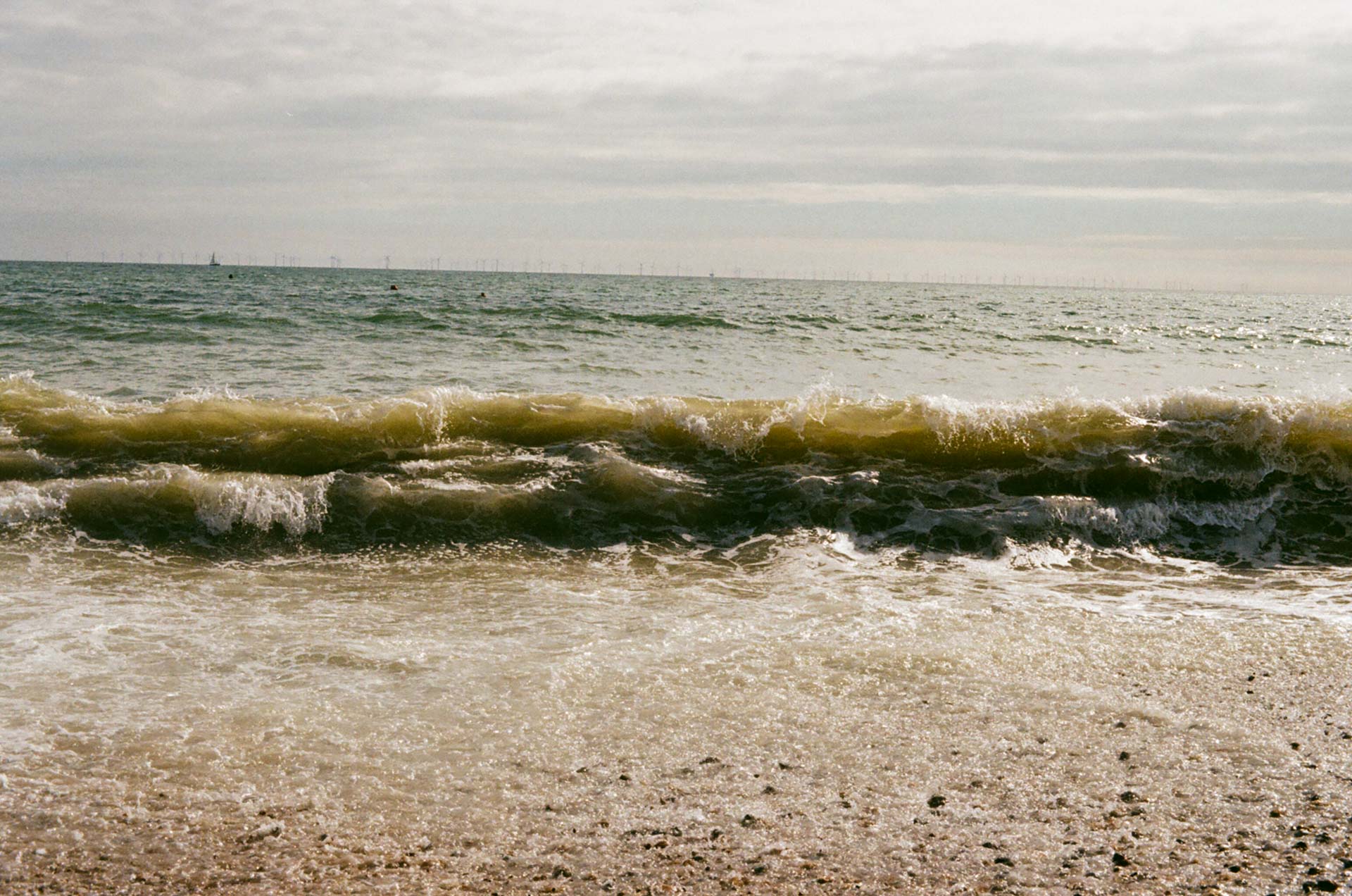 Breaking waves on Brighton beach in Summer
