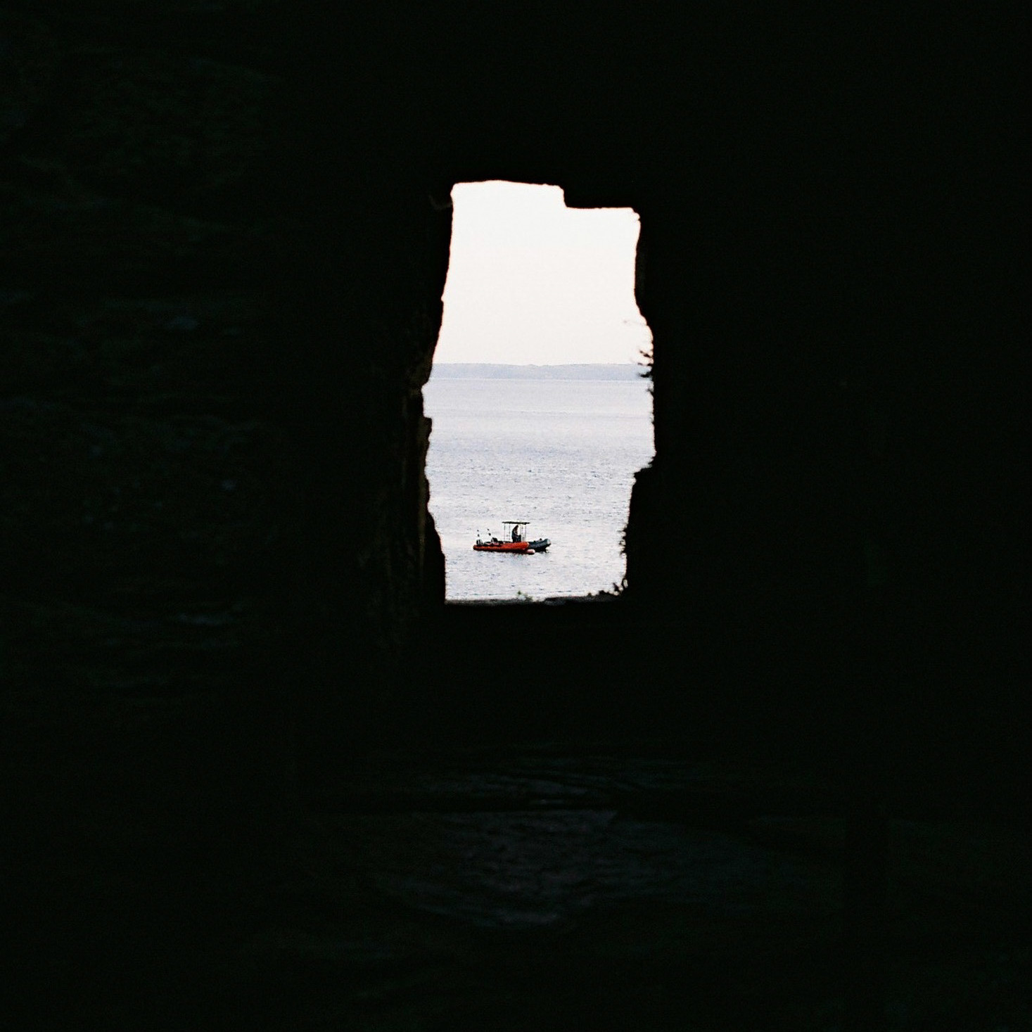 A picture of a boat on the sea from Polruan blockhouse, Cornwall, taken on Kodak Gold 200 film stock.
