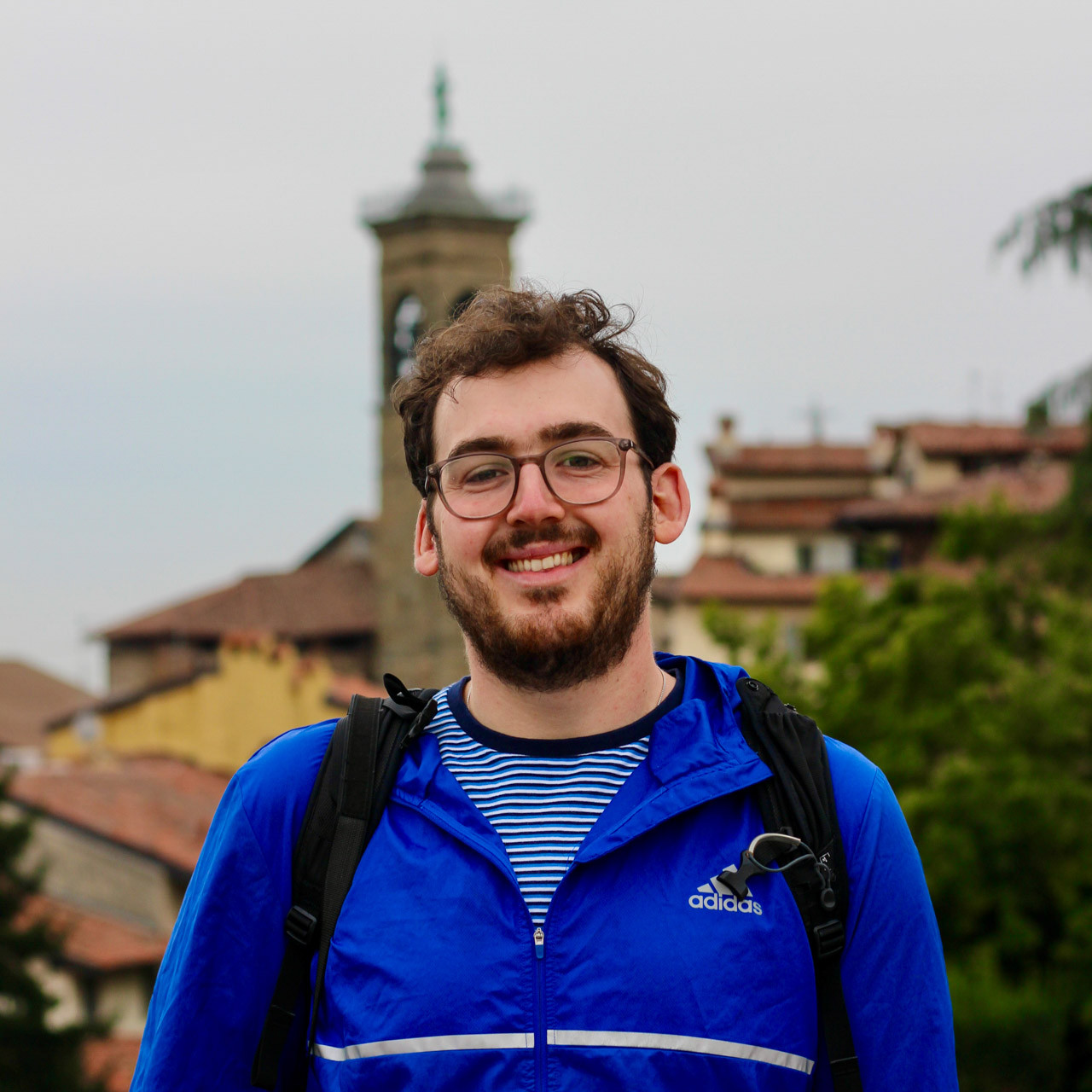 A portrait of Fred Ostrovskis-Wilkes smiling whilst in Citta Alta, Bergamo in Italy.