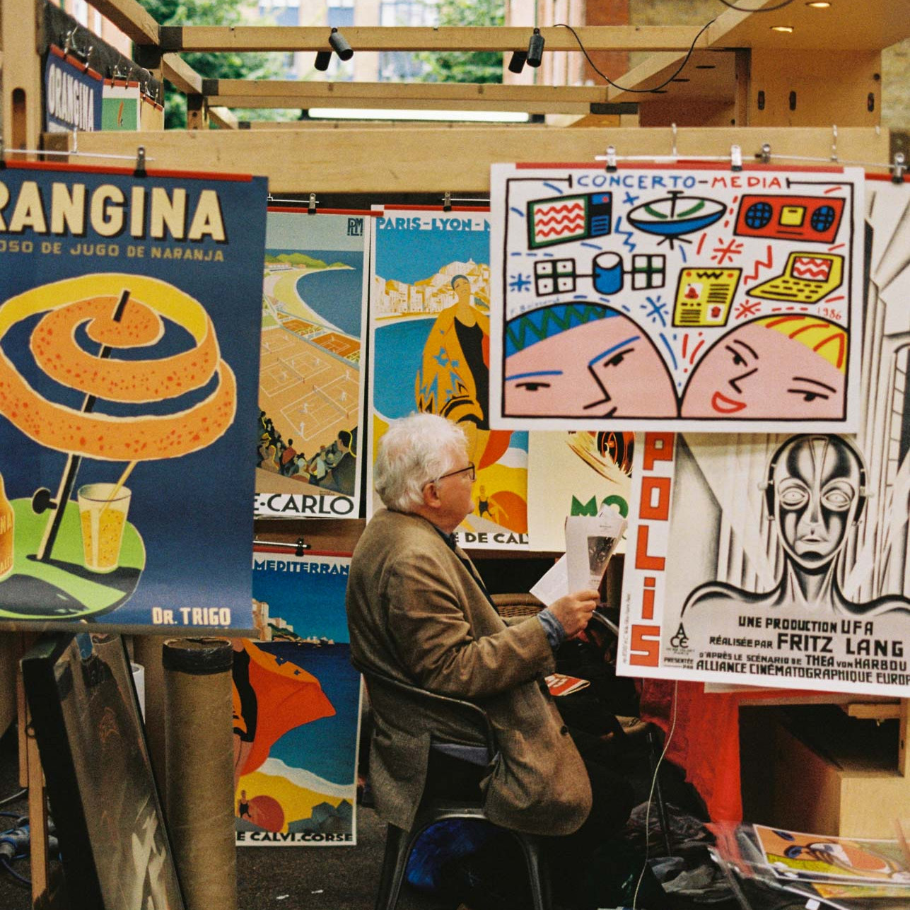 A man sells posters in Spitalfields Market taken on Kodak Gold 200 film stock.