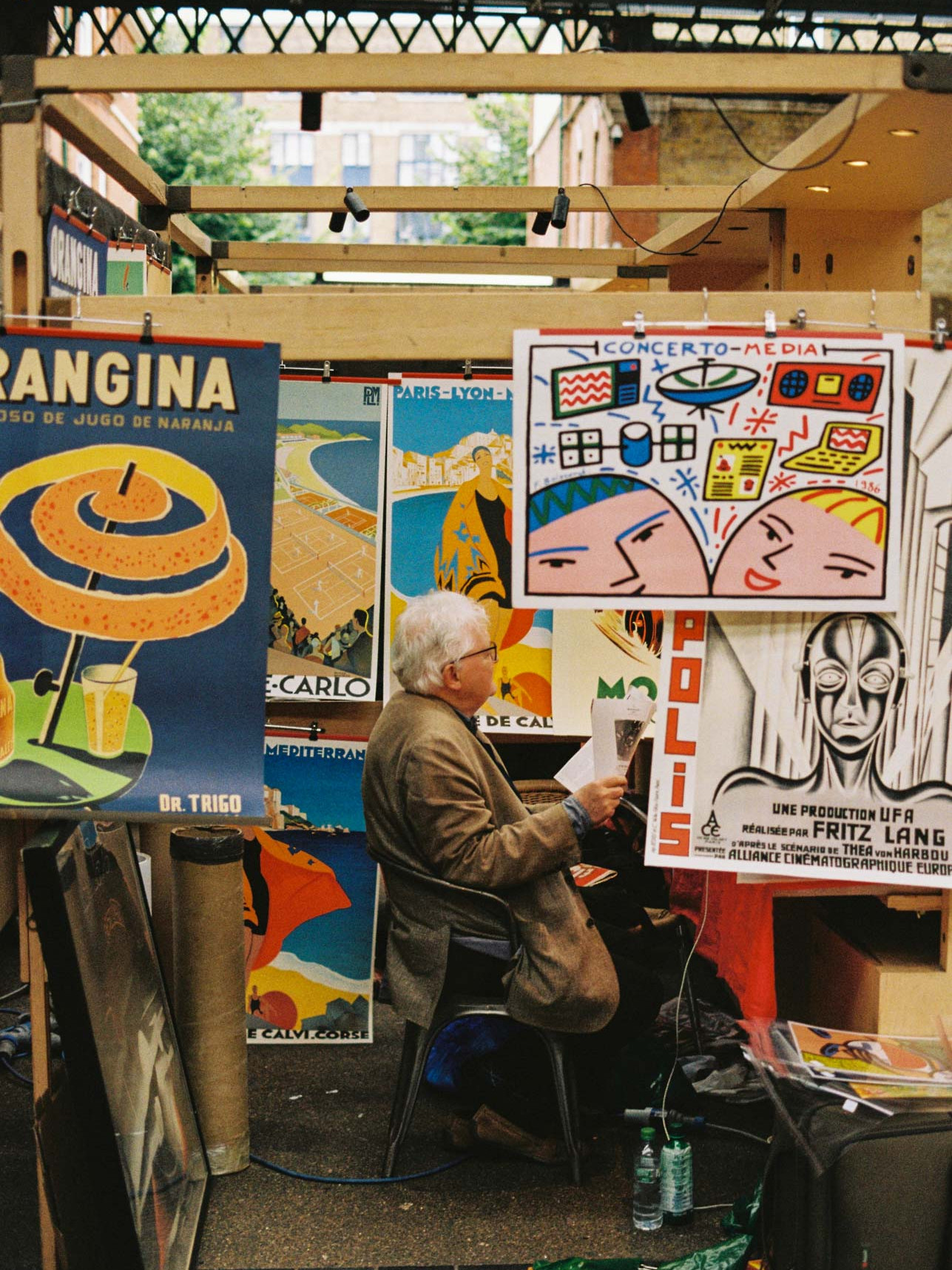 A man sells posters in Spitalfields Market taken on Kodak Gold 200 film stock.