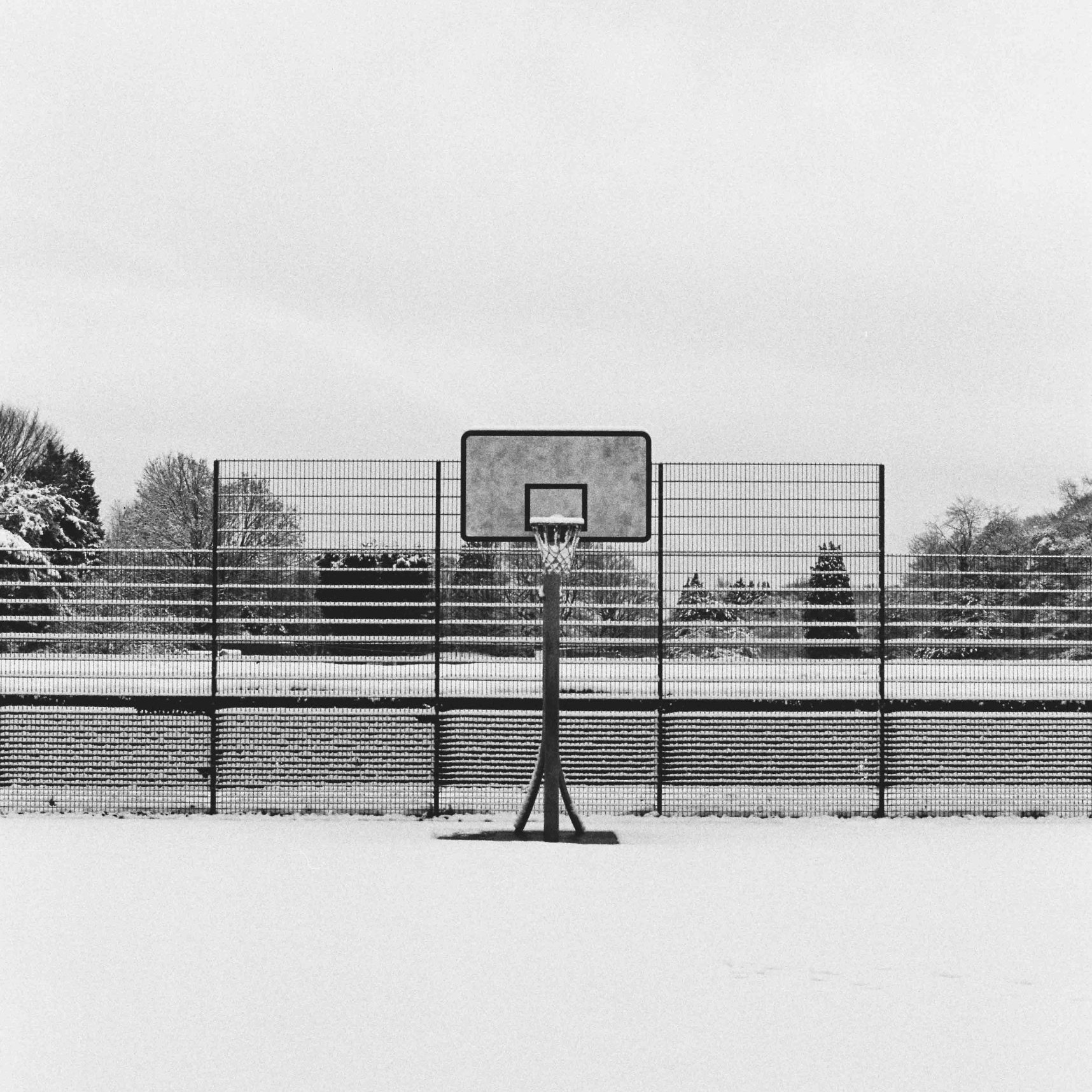 Millhouses Park basketball court in the snow, Sheffield, taken on Ilford HP5 Plus film stock