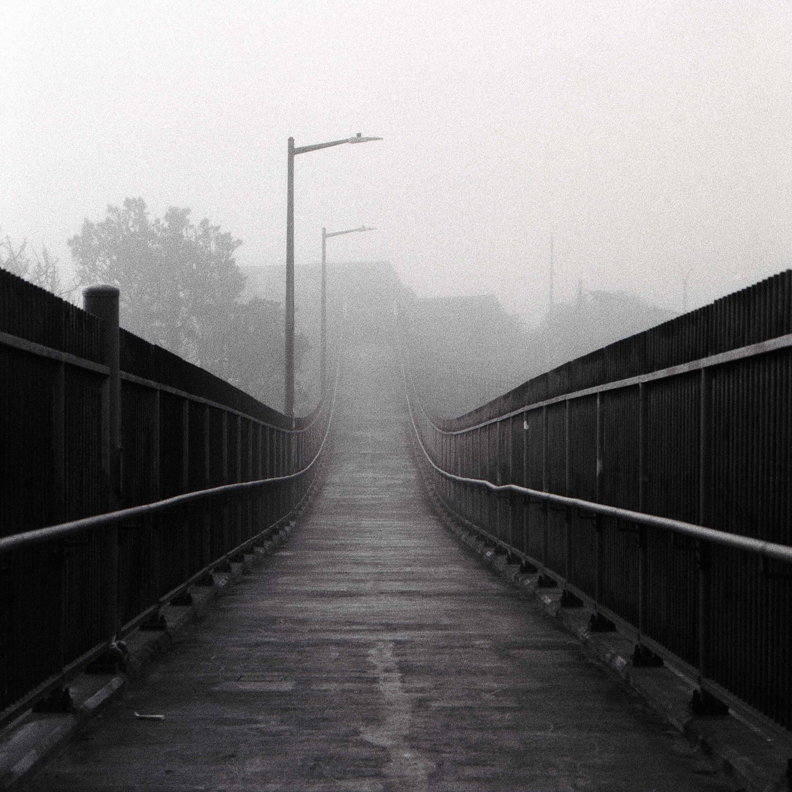 A view across a long bridge in morning fog in San Francisco