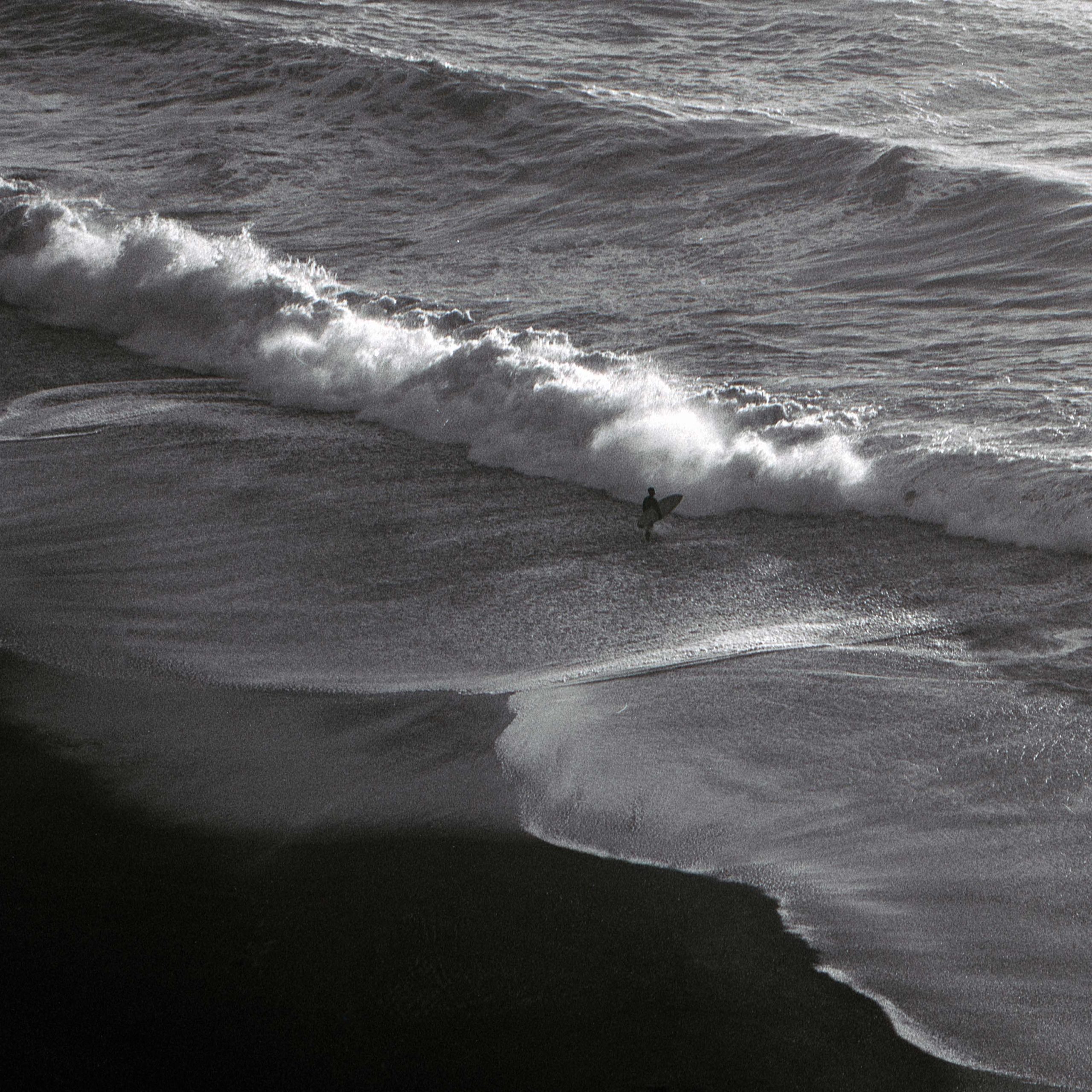 A surfer in front of a wave in San Francisco