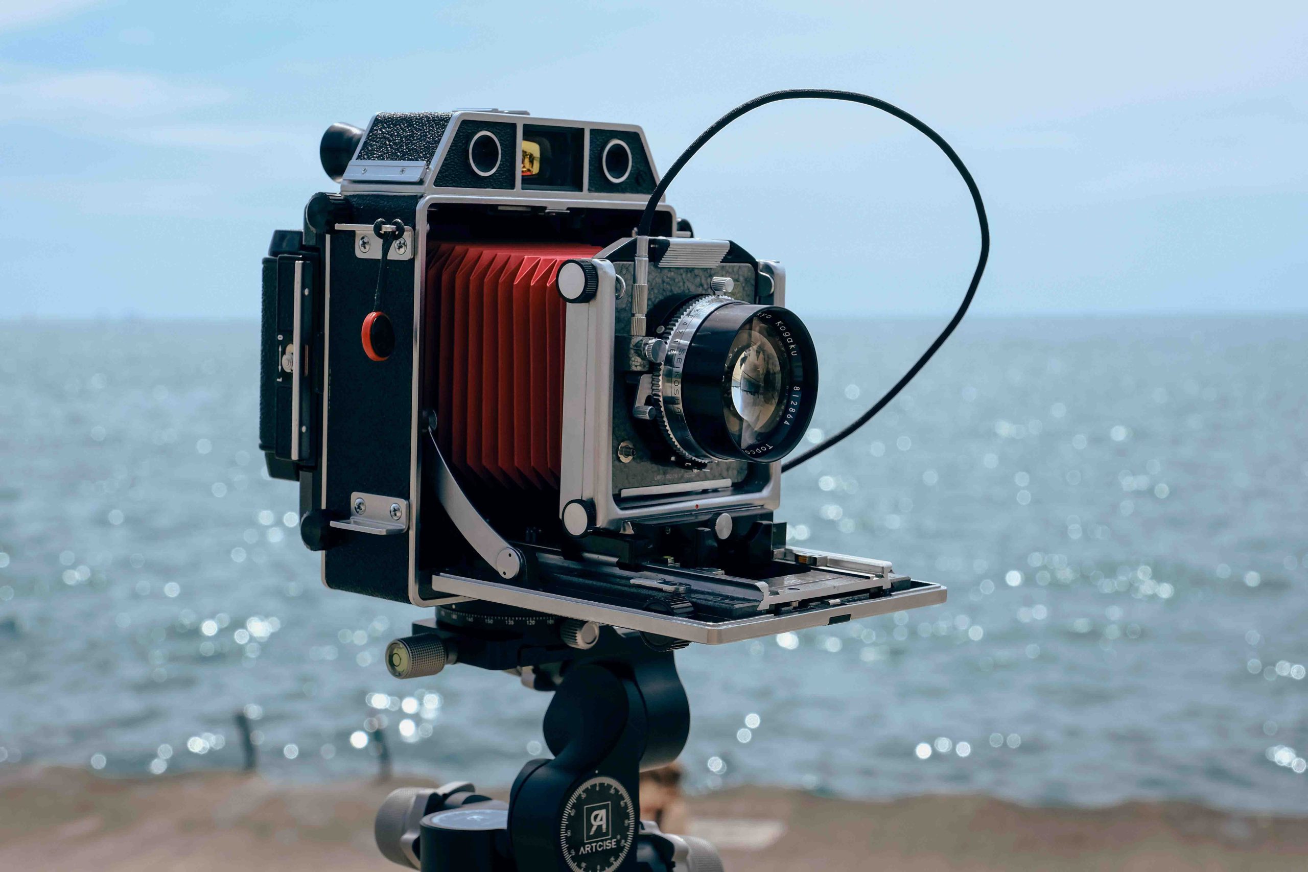 An antique large format film camera by the seaside