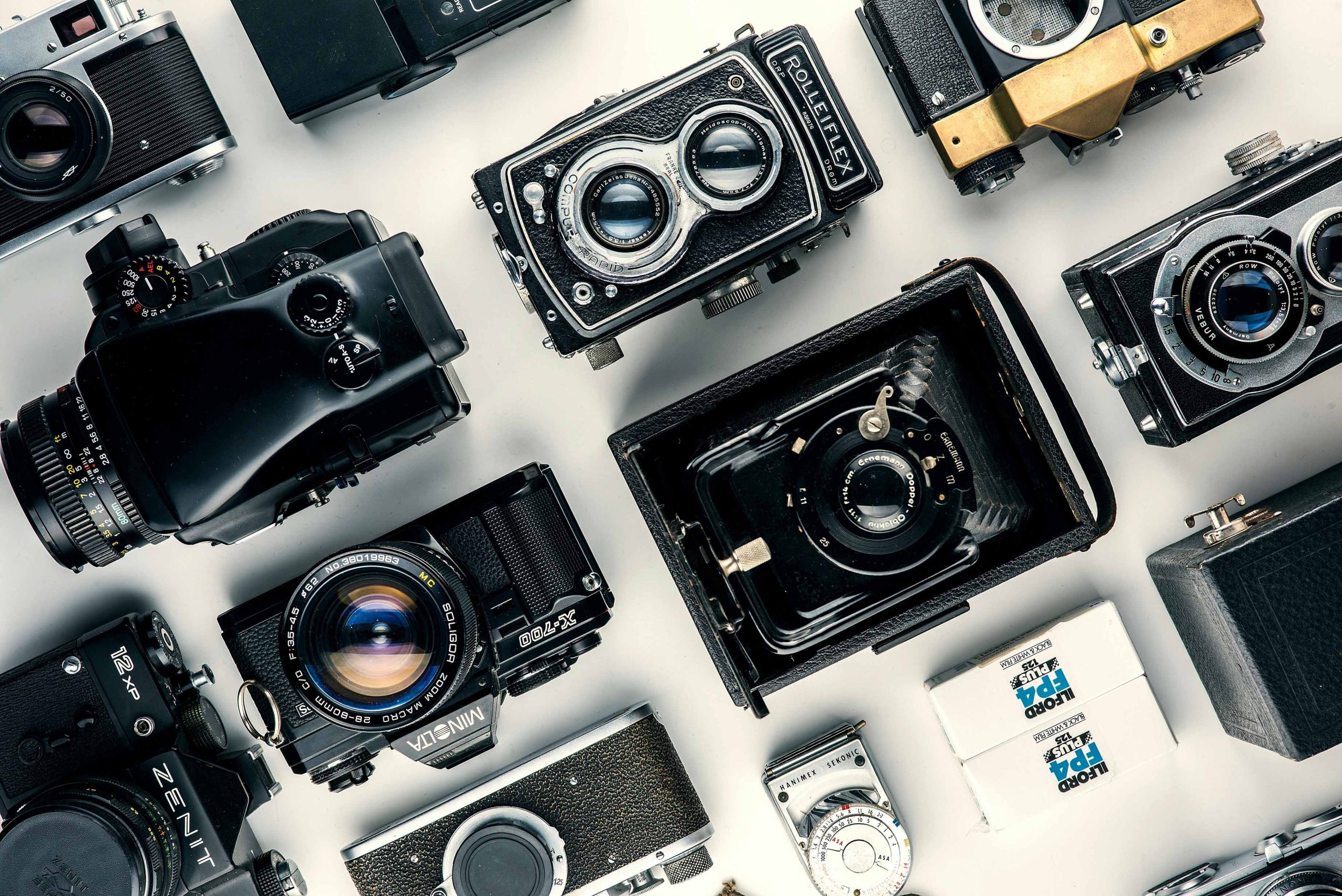 Various types of film cameras together on a table