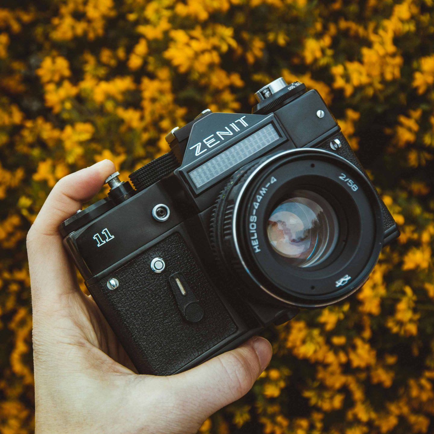 A hand holding a Zenit 11 Film camera