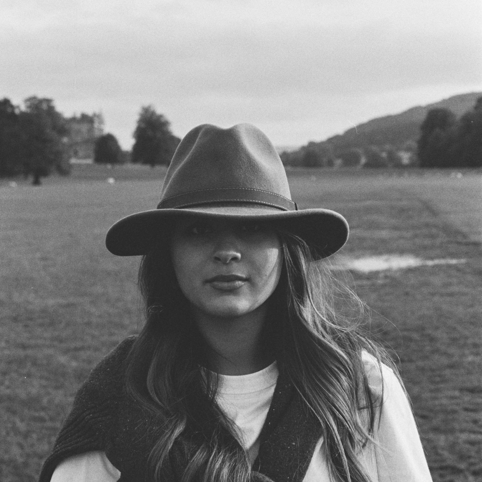 A portrait of Sara wearing a hat at Chatsworth